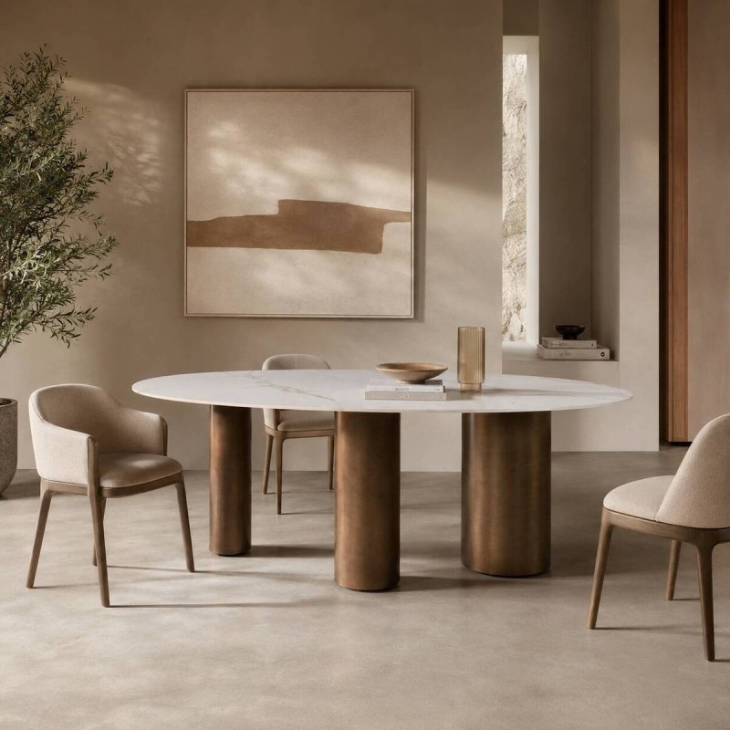 Oval ceramic table with brushed bronze cylindrical legs, 220x110x76cm