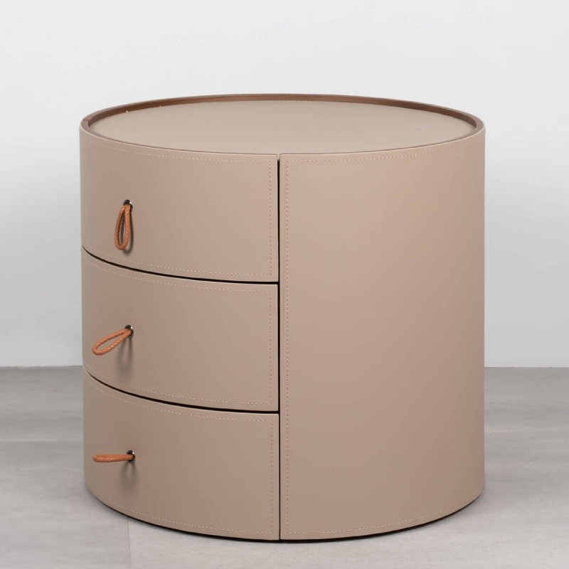 Velien round bedside table upholstered in leather with three drawers